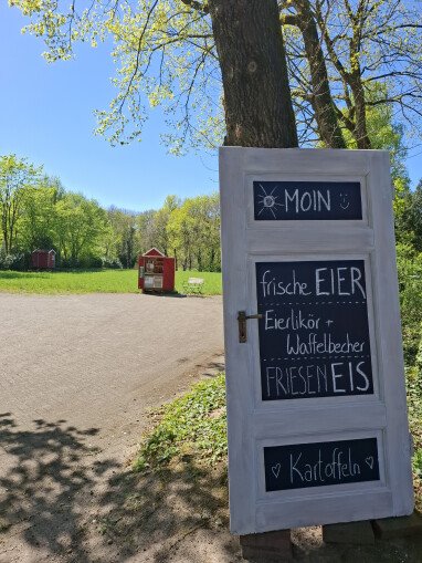 Blick von der Hofeinfahrt auf unser Verkaufshäuschen und Hühnerstall