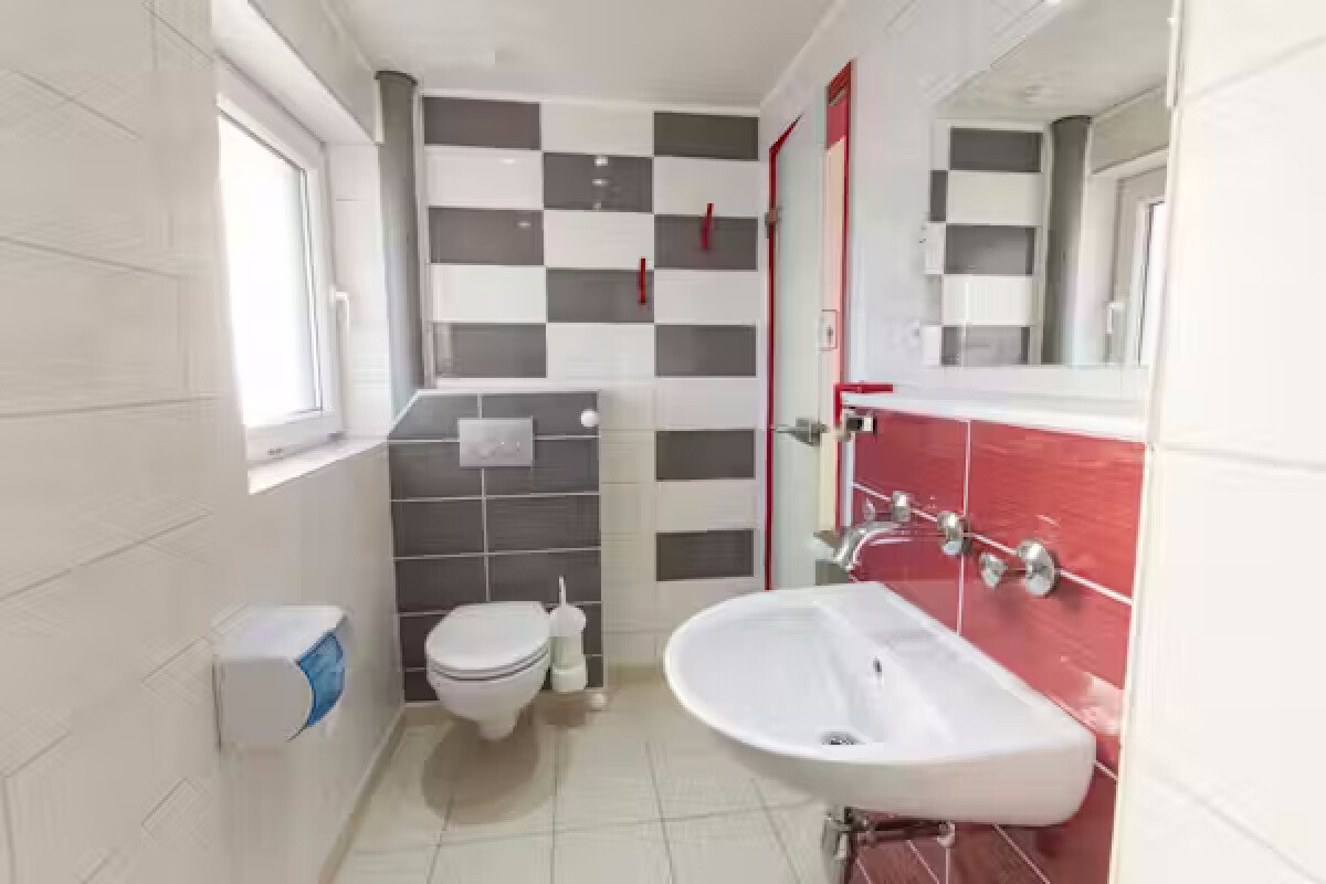Camping-Paradies-Gruener-Jaeger---Innenansicht-des-Sanitaergebaeudes---Toilette-und-Waschbecken-mit-Spiegel-d025c131-b5a5-4872-b7ca-d2d9934f0810